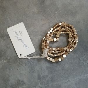 Bracelet multi strand gold metal beads.